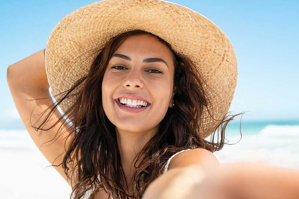 tampa hydrafacial model wearing hat