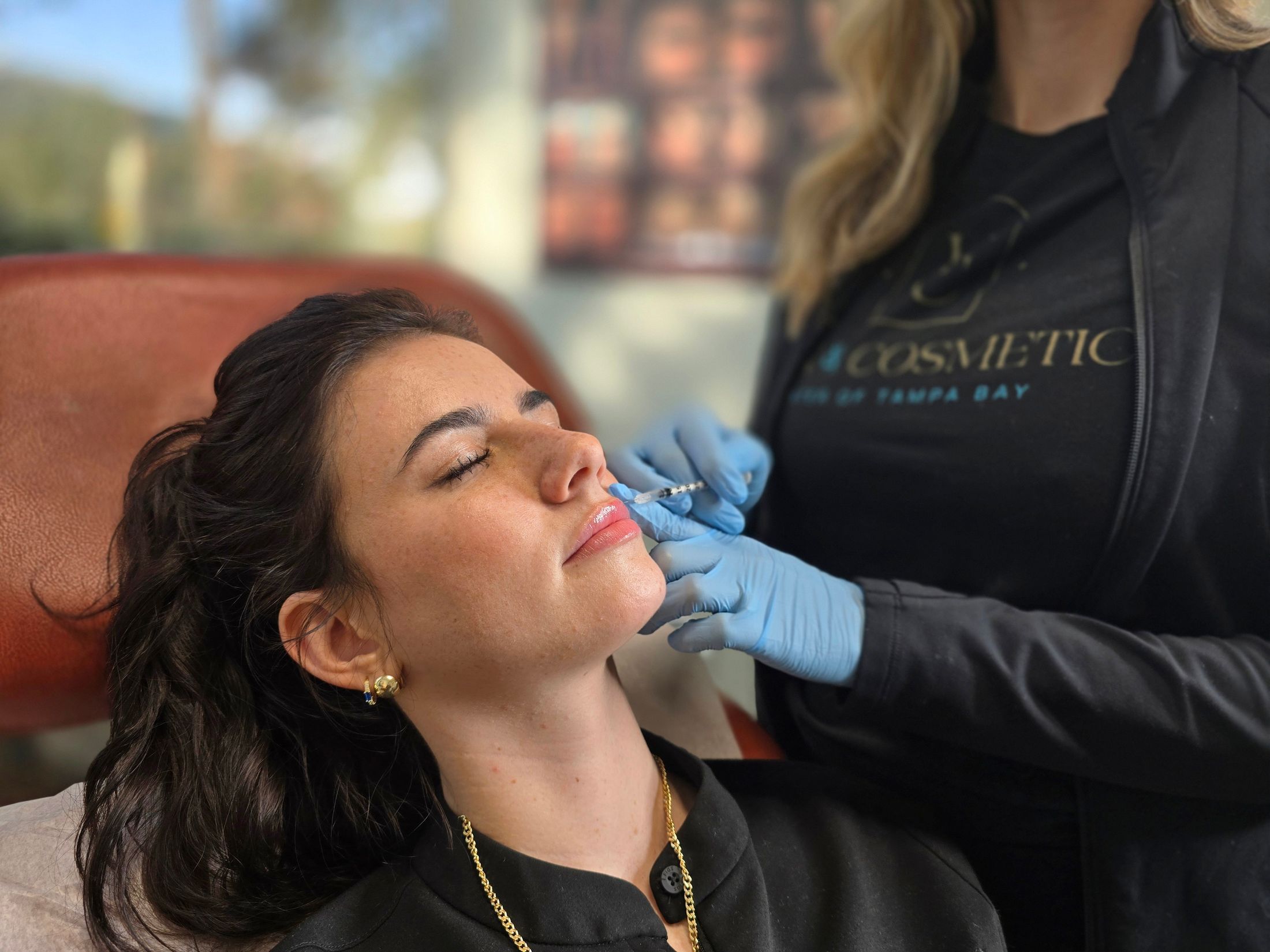 Lip enhancement procedure with syringe and gloves.